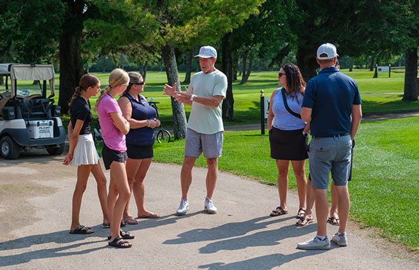 Ray Kuik talks to some of the volunteers and golfers before the tournament