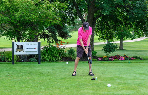 Teeing-off at the hole sponsored by X-Promo